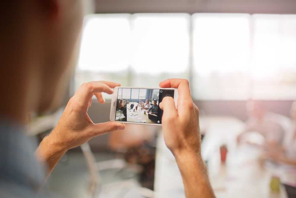 Woman taking a video on her phone