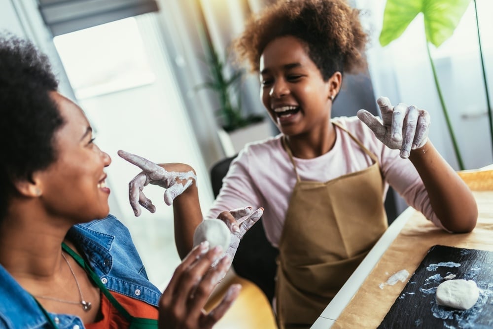 Mother and daughter spend time together and sculpting from clay at home