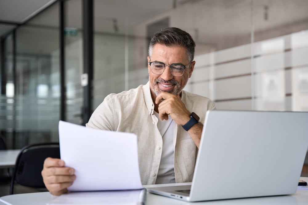 Smiling man looking at document