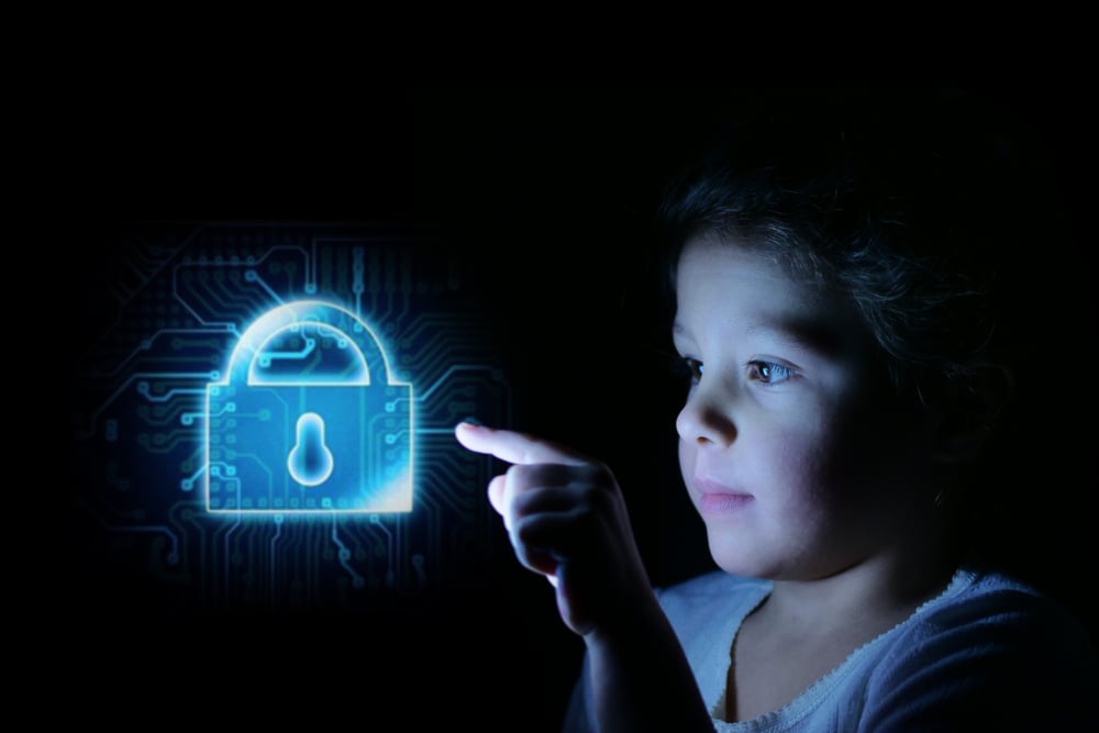 A little girl presses her finger in front of her and bright futuristic graphics appear on privacy.